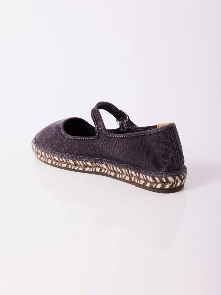 A rear studio product angle shows the back heel structure and patterned midsole stitching of the Free People Oasis Mary Jane Espadrilles - Washed Black | Twentyseven Toronto