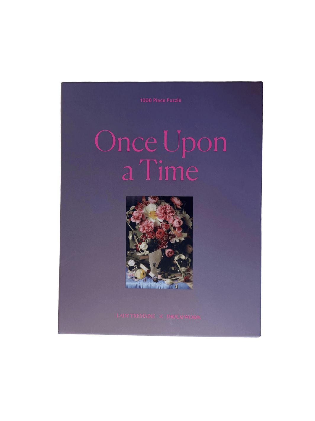 Purple puzzle packaging titled 'Once Upon a Time' 1000 piece puzzle by Piecework Puzzles with a floral photograph on a transparent background | Twentyseven Toronto