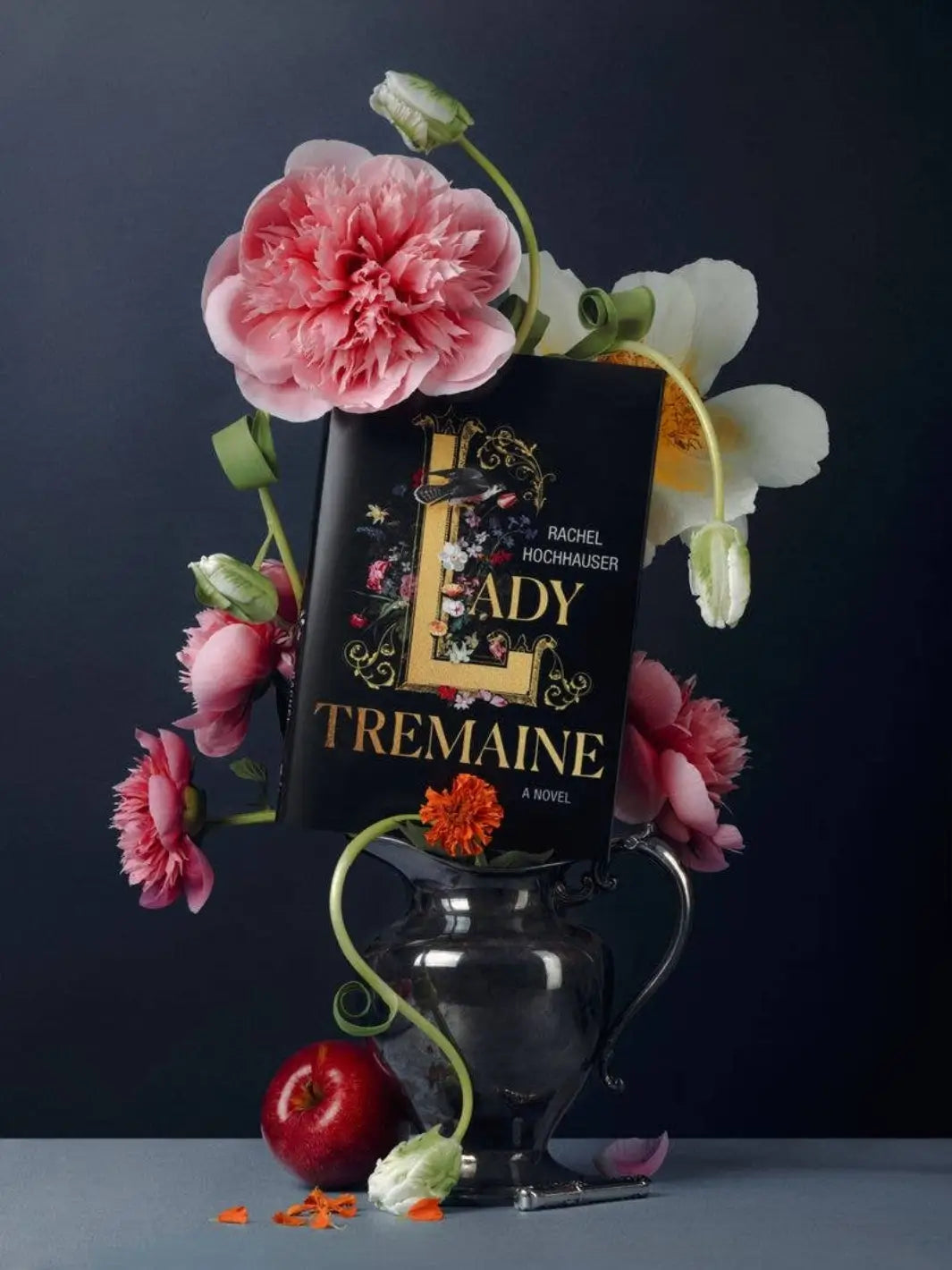 Book titled 'Lady Tremaine' with flowers and an apple on a dark background by Piecework Puzzles | Twentyseven Toronto