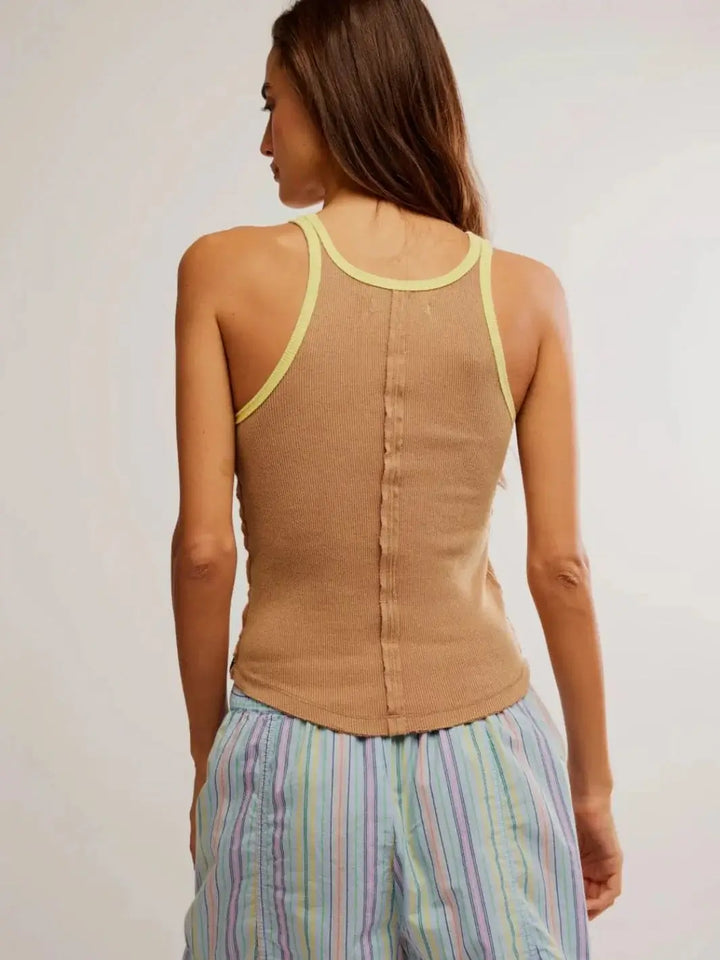 A back view displays the scoop racerback styling and raw-edge spine seam of the Free People Only 1 Solid Ringer Tank - Praline Sunshine Combo | Twentyseven Toronto