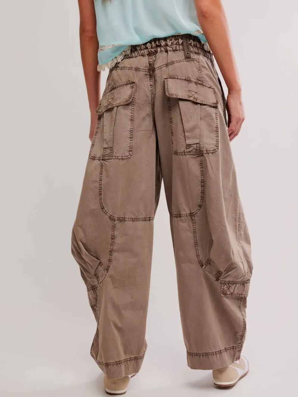 A close-up back view showcases the large flap pockets and slouchy, wide-leg fit of the Free People Onset Cargo Pants in Dusted Cocoa | Twentyseven Toronto
