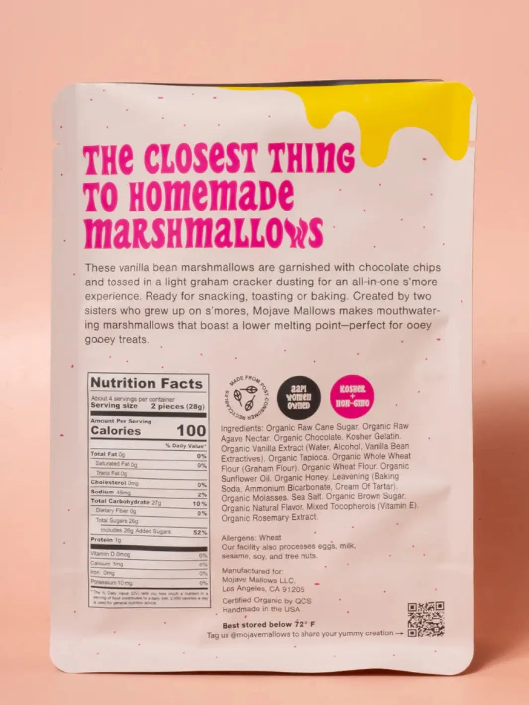 The back of a white pouch of Mojave Mallows Organic S'more Speckled Marshmallows displays bold pink text, a detailed nutrition facts panel, and an ingredients list against a solid pink background | Twentyseven Toronto