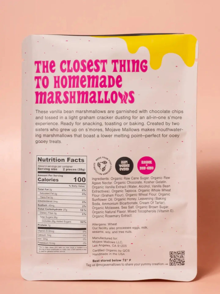 The back of a white pouch of Mojave Mallows Organic S'more Speckled Marshmallows displays bold pink text, a detailed nutrition facts panel, and an ingredients list against a solid pink background | Twentyseven Toronto