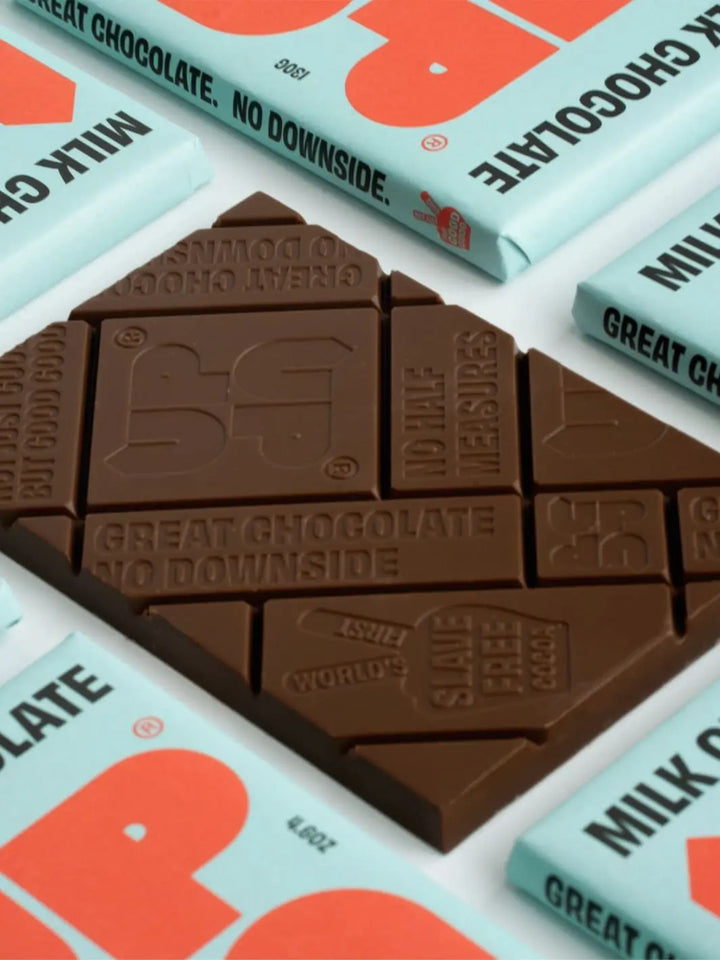 Milk chocolate bar with 'Up Up Chocolate' branding on a light blue and orange background | Twentyseven Toronto
