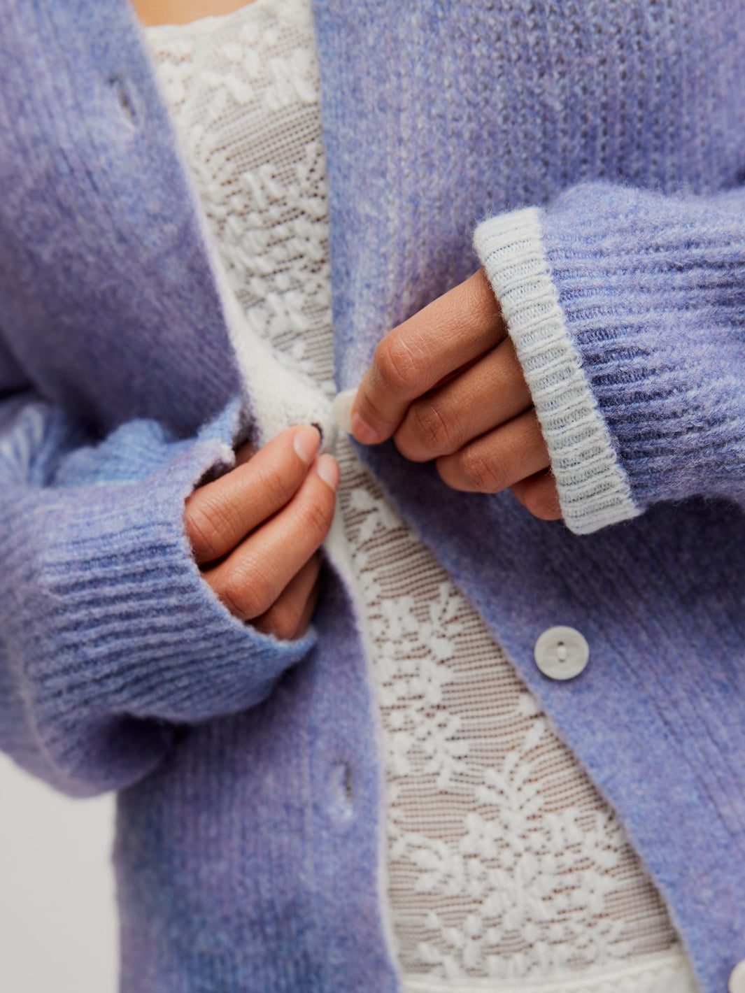 Close-up of the Free People Otillie Cardi in Lilac Combo, featuring a soft fuzzy knit, button front and contrast ribbed cuffs | Twentyseven Toronto