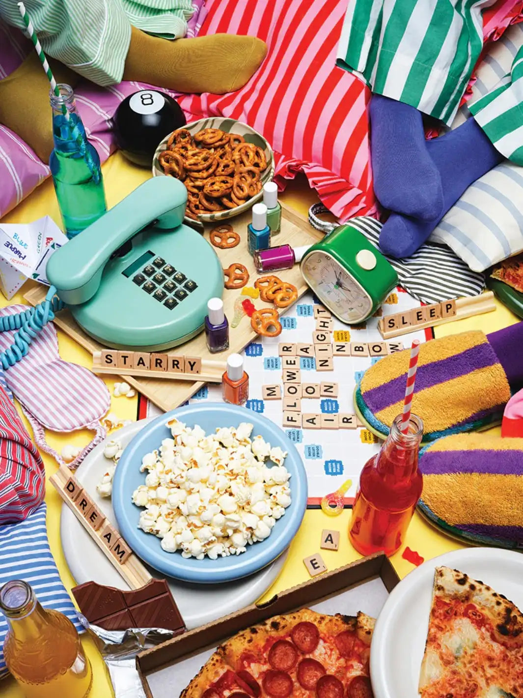 Piecework Puzzles 'Pajama Party' 1000 piece puzzle featuring a colourful table setting with snacks, drinks, and a rotary phone | Twentyseven Toronto