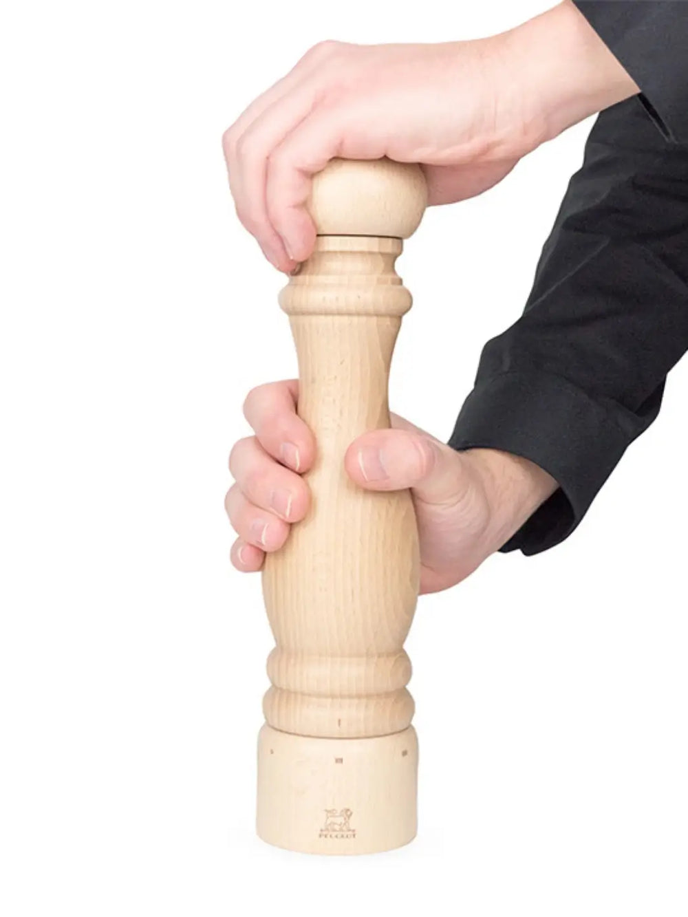 Hand holding wooden 'Paris U'Select' pepper grinder in 'Natural Finish' from Peugeot on a white background | Twentyseven Toronto