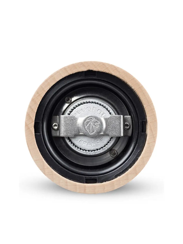 Close-up of a 'Paris U'Select Wood Pepper Mill Grinder' mechanical component with a central bearing from Peugeot on a white background | Twentyseven Toronto