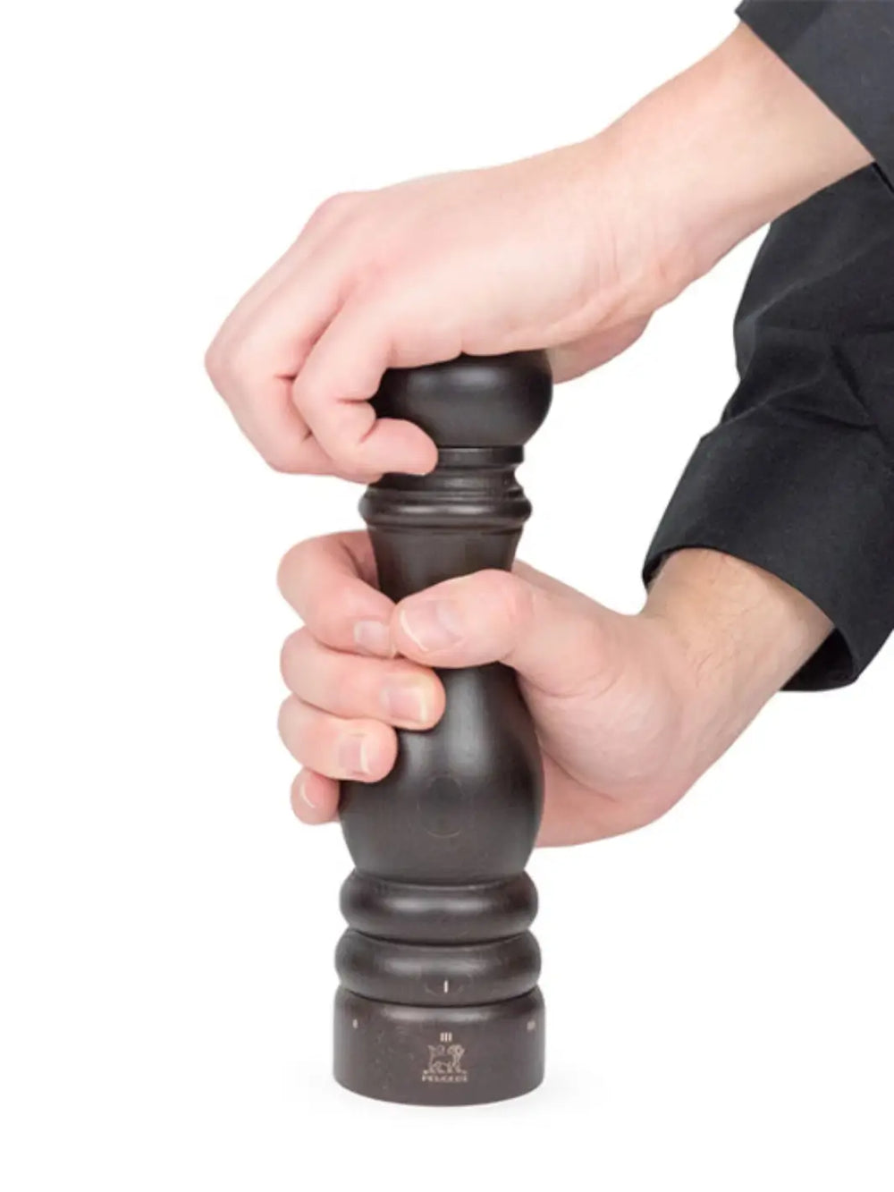 Hand holding black 'Paris U'Select' pepper grinder in 'Chocolate Finish' from Peugeot on a white background | Twentyseven Toronto