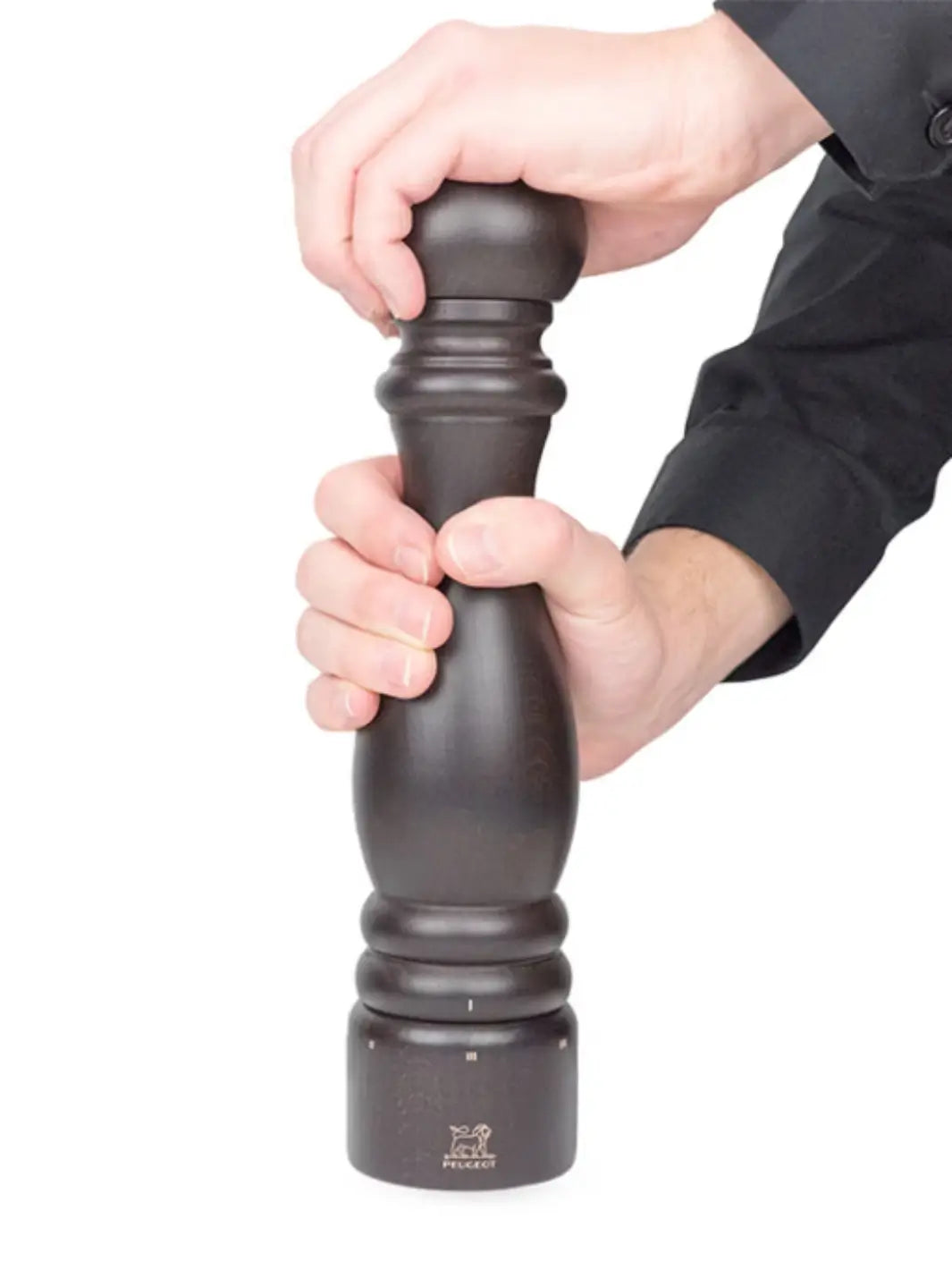 Hand holding black 'Paris U'Select' pepper grinder in 'Chocolate Finish' from Peugeot on a white background | Twentyseven Toronto