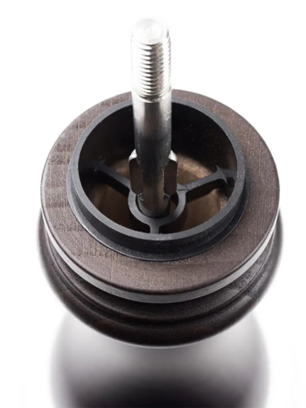 Close-up of a metal wheel from Peugeot 'Paris U'Select Wood Pepper Mill' with a central shaft on a white background | Twentyseven Toronto