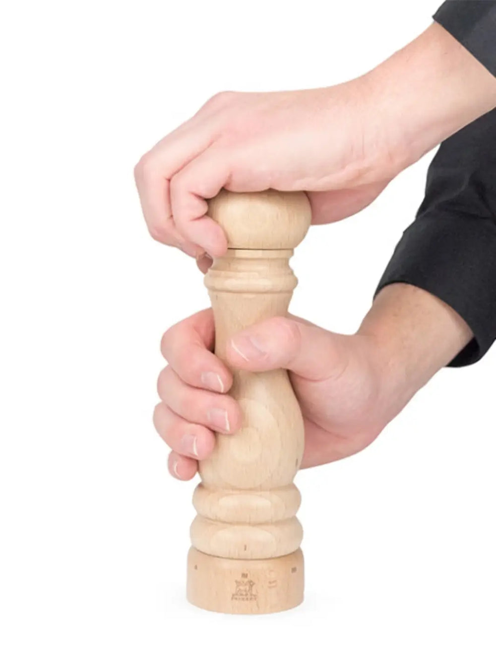 Hand holding wooden 'Paris U'Select' pepper grinder in 'Natural Finish' from Peugeot on a white background | Twentyseven Toronto