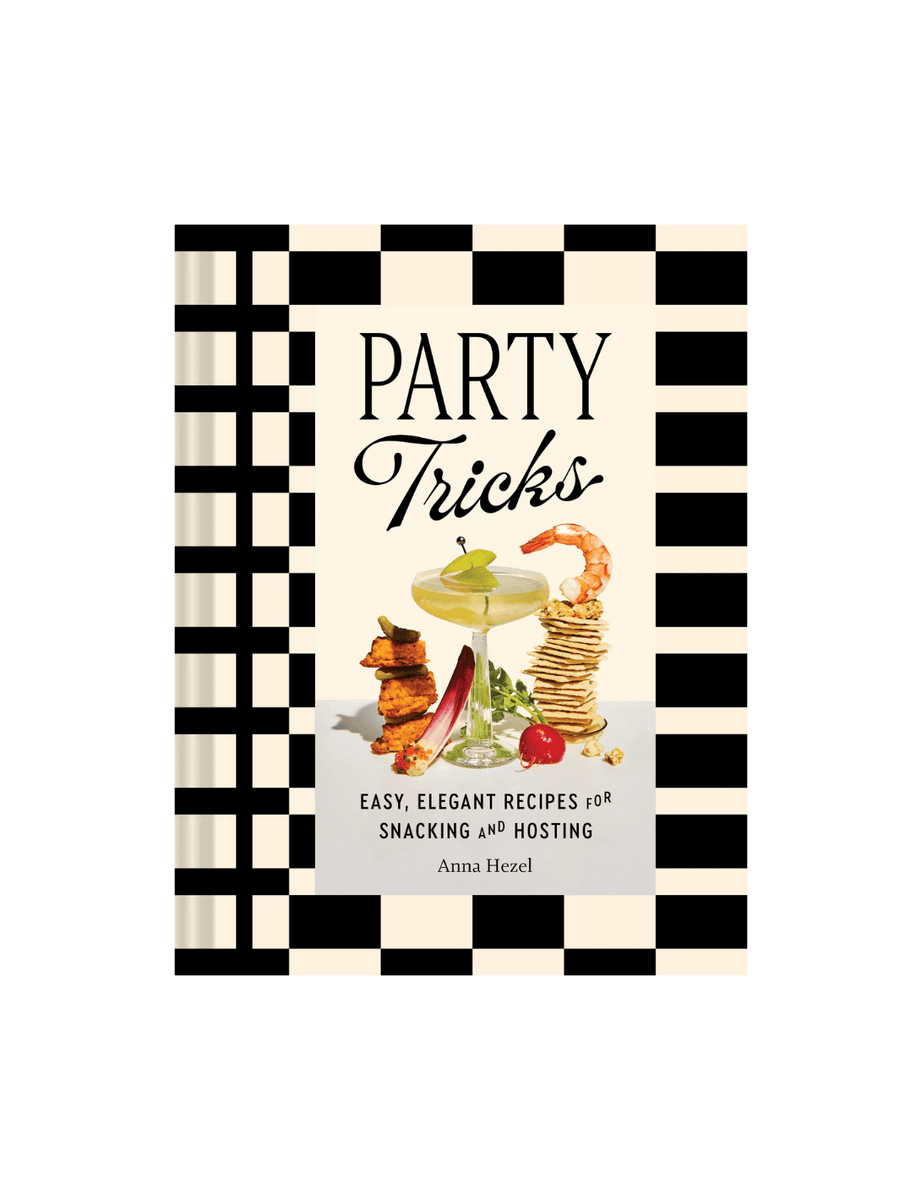 Front cover of Party Tricks: Easy, Elegant Recipes for Snacking and Hosting by Anna Hezel, featuring a black-and-white checkered border and a central photograph of a cocktail glass surrounded by stacked snacks | Twentyseven Toronto