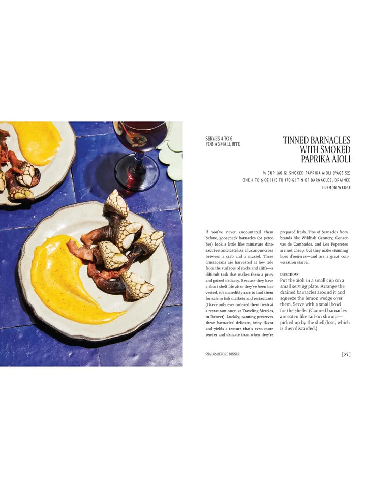Spread from Party Tricks: Easy, Elegant Recipes for Snacking and Hosting by Anna Hezel featuring a recipe for Tinned Barnacles with Smoked Paprika Aioli, with a photograph of the unique seafood served on small plates with a creamy yellow sauce | Twentyseven Toronto