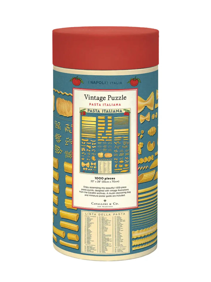 Cylindrical cardboard puzzle container for the Cavallini Paper & Co Pasta 1000 Piece Puzzle, displaying a red cap and a blue wrap-around label illustrated with numerous shapes of Italian pasta against a white background | Twentyseven Toronto