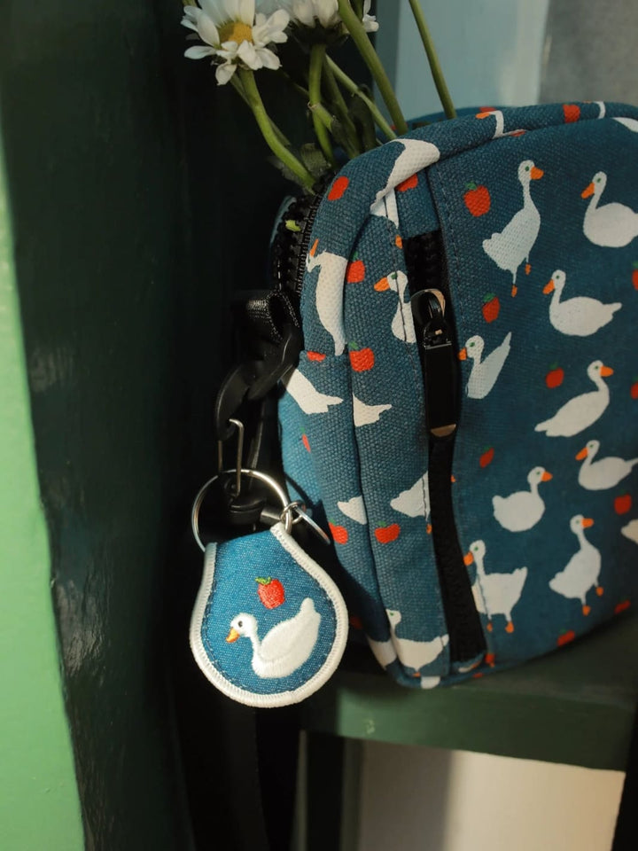Keychain with goose and apple design on a backpack from the brand 'Three Potato Four' | Twentyseven Toronto