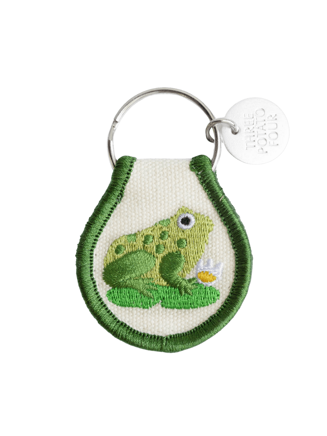 A Three Potato Four Patch Keychain - Frog with embroidered green detailing and a metal logo tag | Twentyseven Toronto