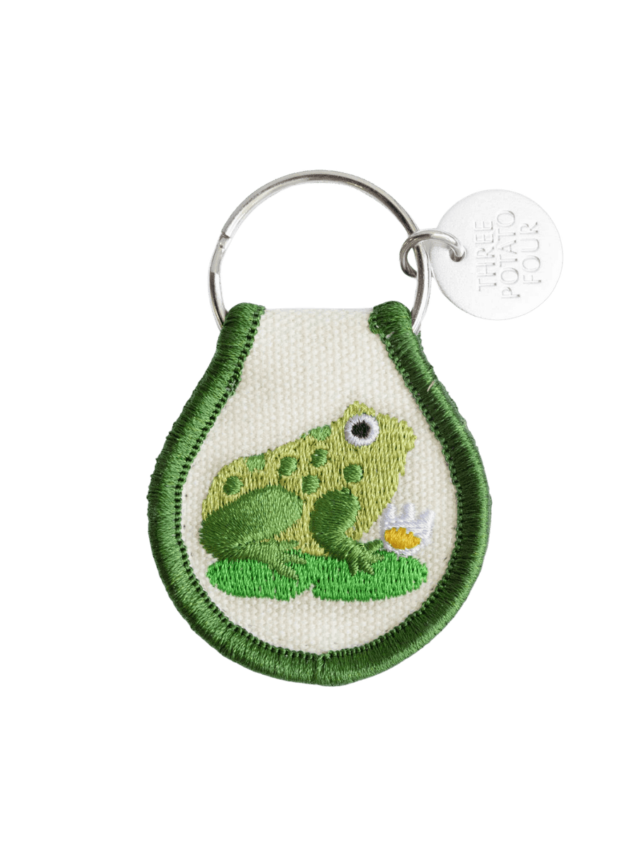 A Three Potato Four Patch Keychain - Frog with embroidered green detailing and a metal logo tag | Twentyseven Toronto