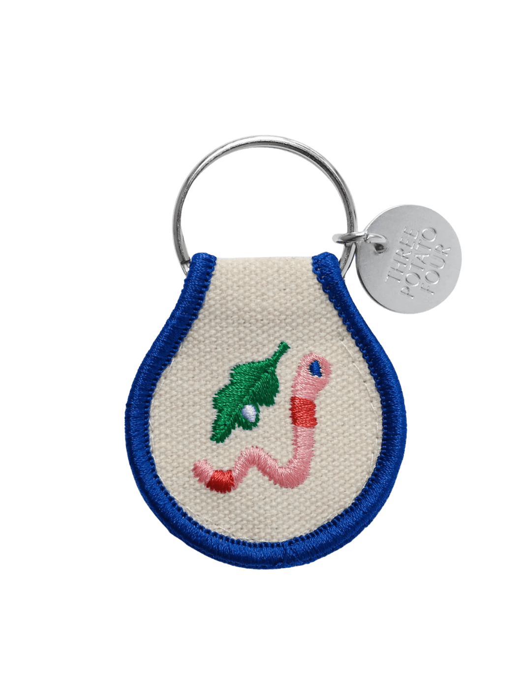 A Three Potato Four Patch Keychain - Worm featuring a pink embroidered worm next to a green leaf | Twentyseven Toronto