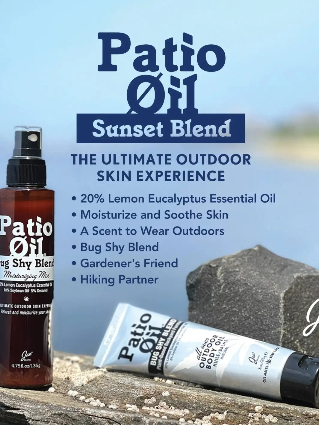 A promotional banner for Jao Brand Patio Oil Sunset Blend featuring a spray bottle and a squeeze tube resting on a rustic wooden log against a blurred blue water background | Twentyseven Toronto