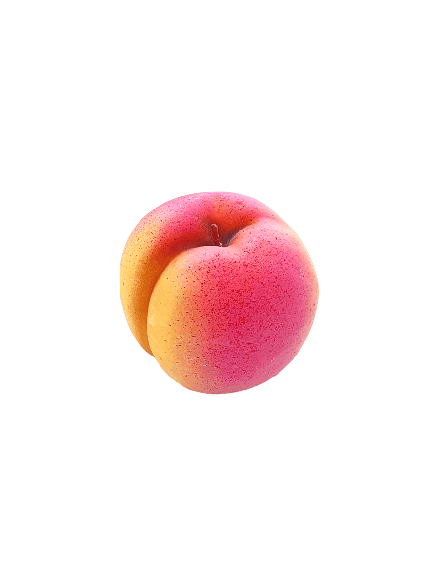 Peach shaped candle from Cereria Introna on a transparent background | Twentyseven Toronto