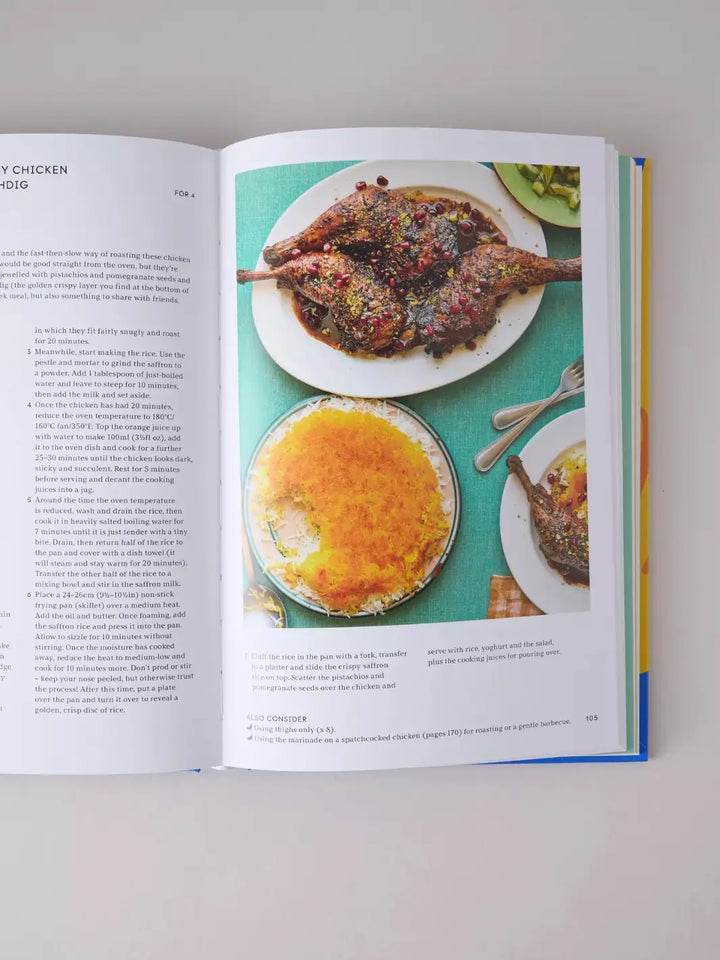Page from the cookbook Peckish: An Inspirational Collection of Winning Chicken Dinners by Ed Smith displays a recipe for chicken with saffron rice, accompanied by roasted chicken legs garnished with pomegranate seeds and pistachios next to a golden, crispy disc of tahdig rice | Twentyseven Toronto