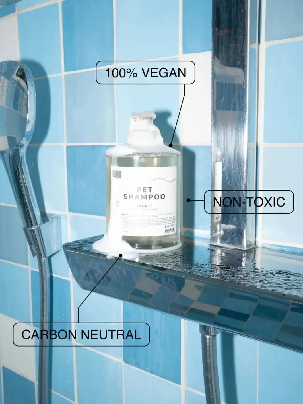 Bottle of Dedcool Pet Shampoo 01 "Taunt" covered in foam sitting on a chrome shelf inside a blue tiled shower stall | Twentyseven