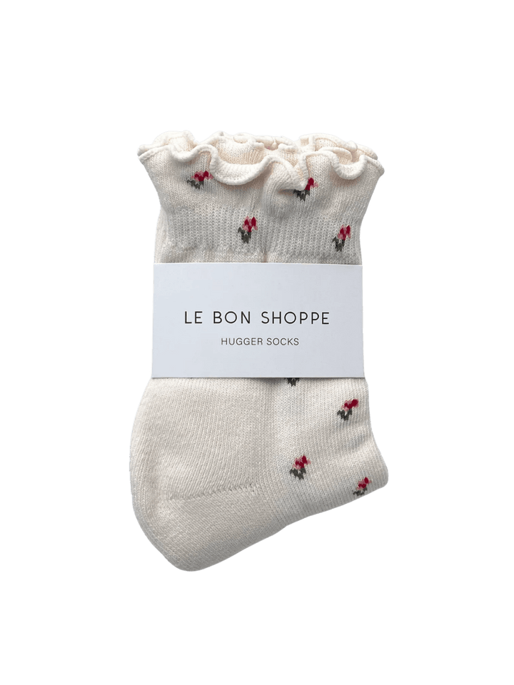 The Le Bon Shoppe Petal Ruffled Hugger Crew Socks in Cream Petal are neatly folded with a white branded paper band around the middle | Twentyseven