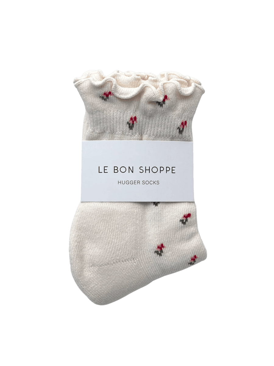 The Le Bon Shoppe Petal Ruffled Hugger Crew Socks in Cream Petal are neatly folded with a white branded paper band around the middle | Twentyseven