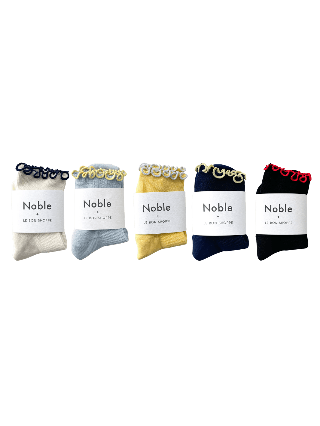 Five pairs of socks from the Le Bon Shoppe The Petite Ruffled Modal Socks Set - Pack of 5, each folded neatly with white "Noble + Le Bon Shoppe" paper bands | Twentyseven Toronto