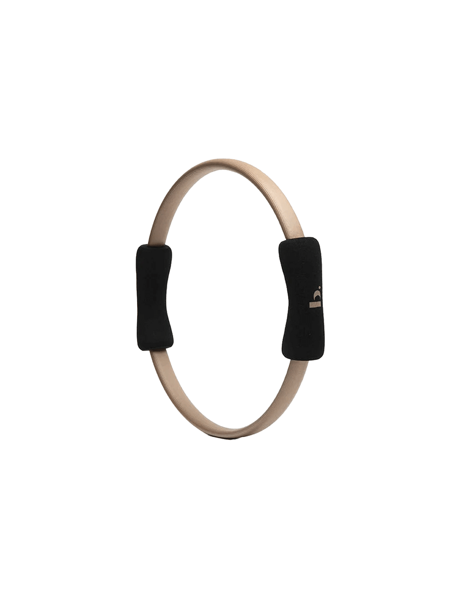 Halfmoon Pilates Ring with black non-slip foam handles on a white background | Twentyseven Toronto
