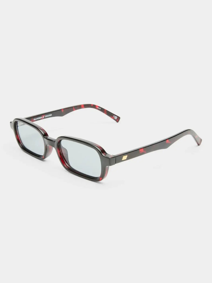 A three-quarter product shot of the dark red tortoiseshell Le Specs Pilferer - Cherry Tort glasses resting on a white studio background | Twentyseven Toronto