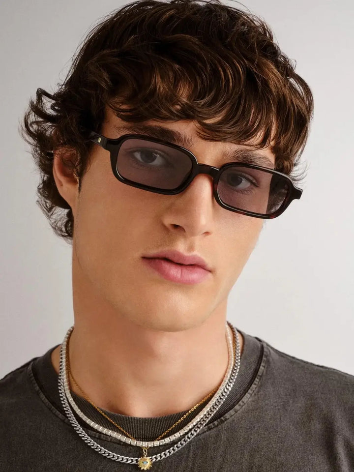 A man wearing the slim, dark rectangular Le Specs Pilferer - Cherry Tort sunglasses | Twentyseven Toronto