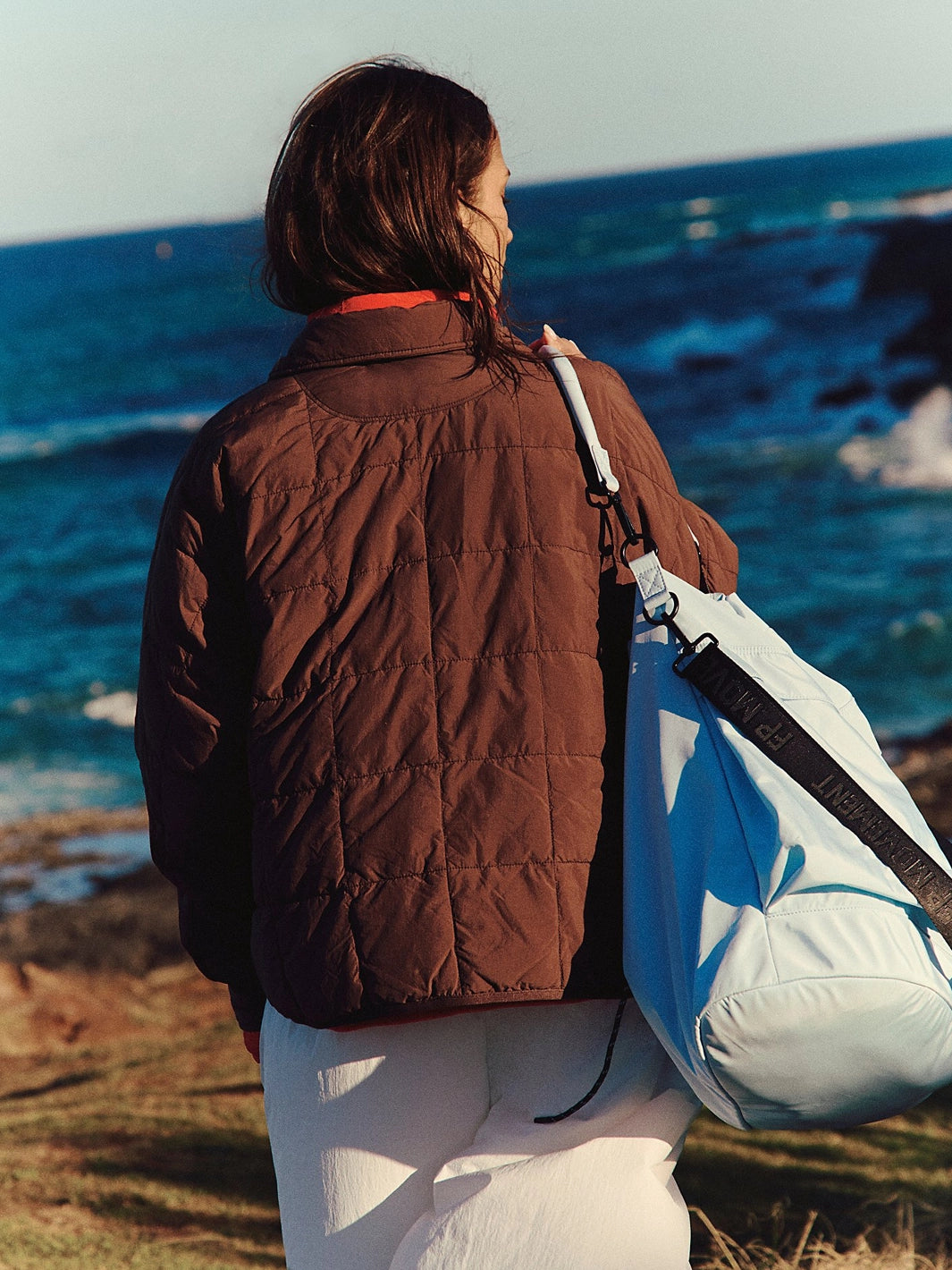 Back view of the Free People Movement Pippa Packable Puffer in Cocoa, featuring a quilted oversized fit and high collar | Twentyseven Toronto