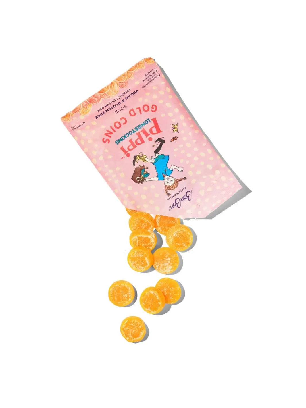 Round, yellow sour candies spill out from an open pink pouch of Pippi Longstocking Gold Coins Swedish Candy from BonBon NYC onto a white background | Twentyseven Toronto