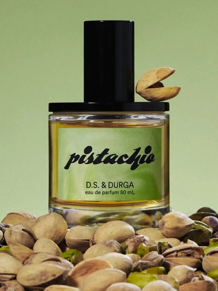 D.S. & Durga 'Pistachio' perfume bottle with pistachios on a green background | Twentyseven Toronto