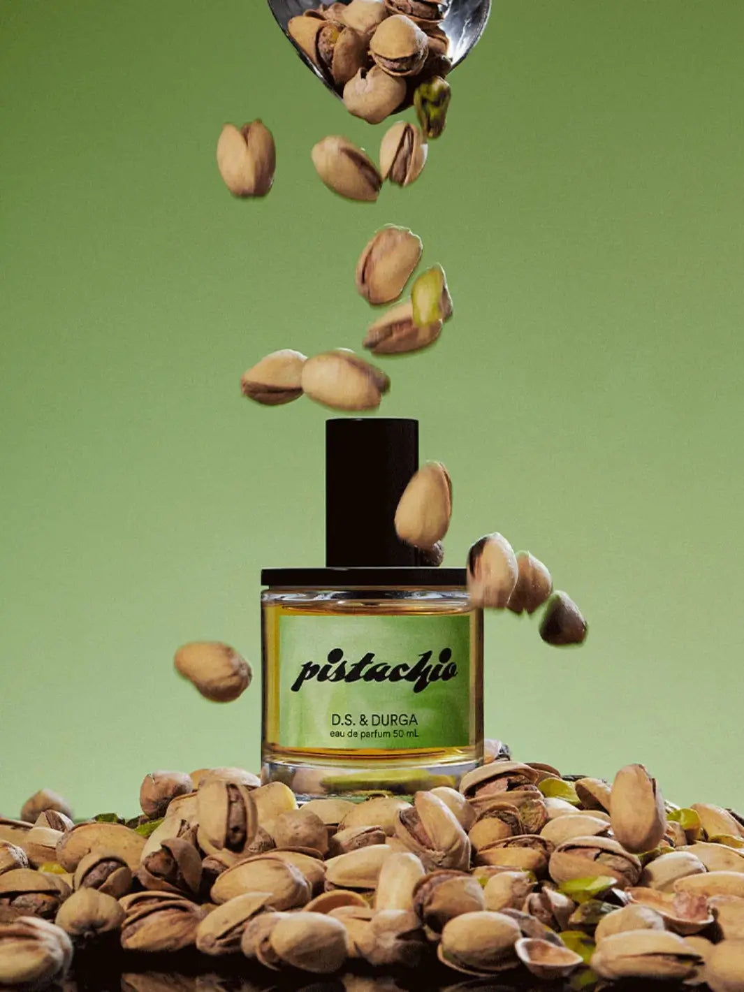 D.S. & Durga 'Pistachio' 50ml perfume bottle surrounded by pistachios on a green background | Twentyseven Toronto