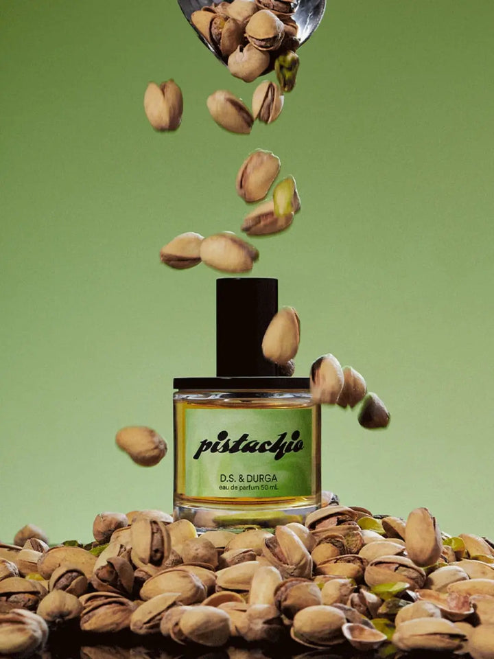 D.S. & Durga 'Pistachio' 50ml perfume bottle surrounded by pistachios on a green background | Twentyseven Toronto