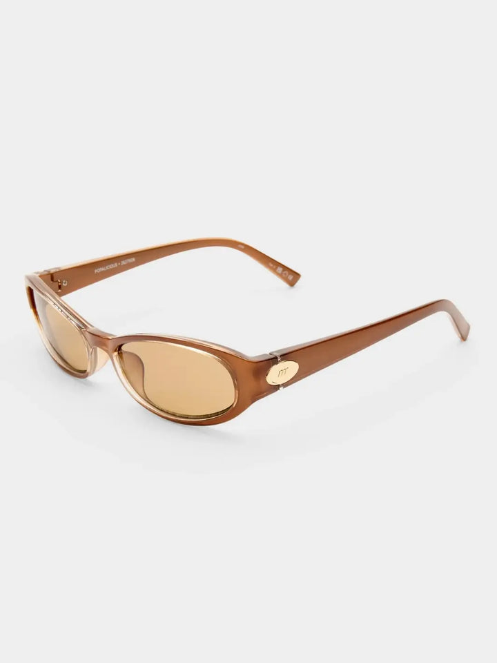 Studio shot of the Le Specs Popalicious + | Pearl Caramel sunglasses showing their translucent brown frame and light brown lenses against a plain white background | Twentyseven Toronto