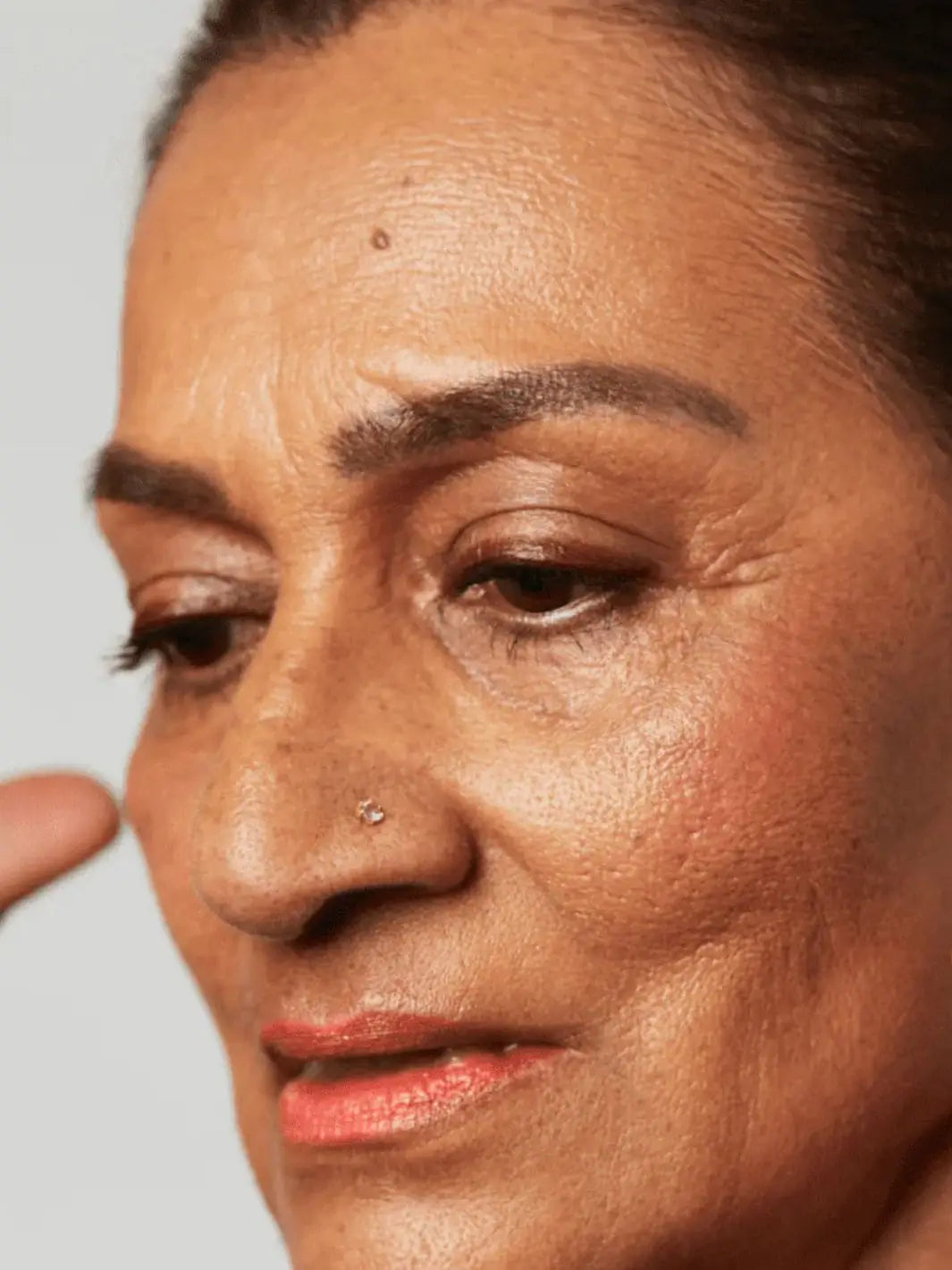 Close-up of a woman with a neutral expression using 19/99 Beauty Precision Colour Pencil in 'Bor' | Twentyseven Toronto