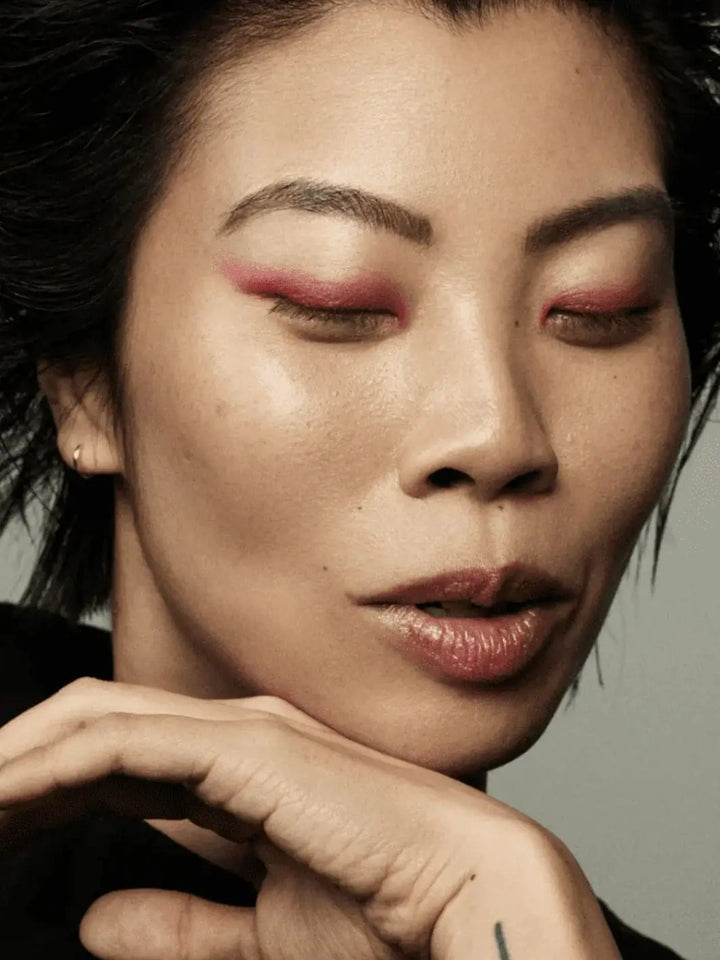 Close-up of a person with pink 19/99 Beauty Precision Colour Pencil in 'Rozsa' eyeliner, resting their head on their hand | Twentyseven Toronto