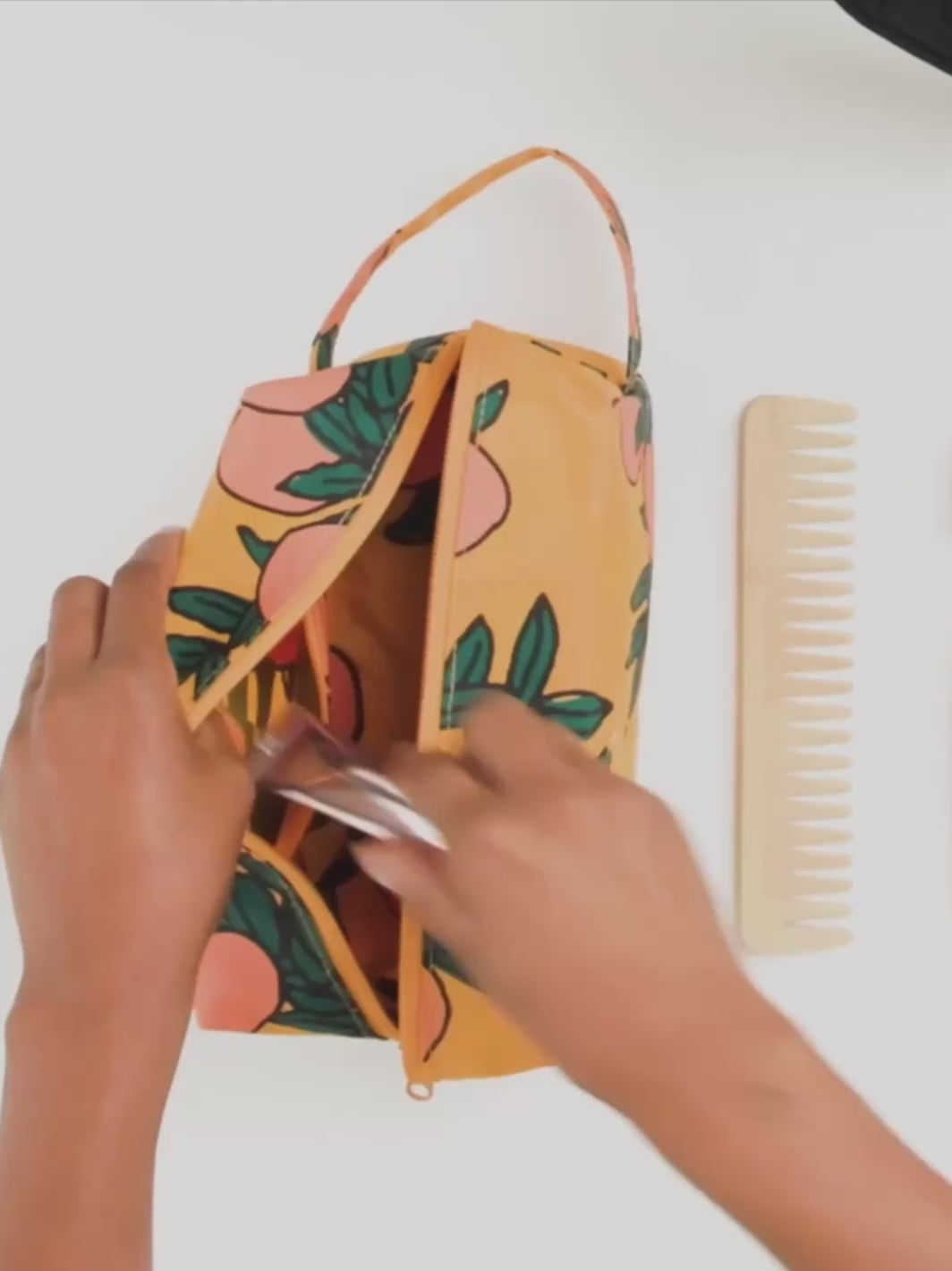 Hands showing how to use the BAGGU Dopp Kit for various toiletries | Twentyseven