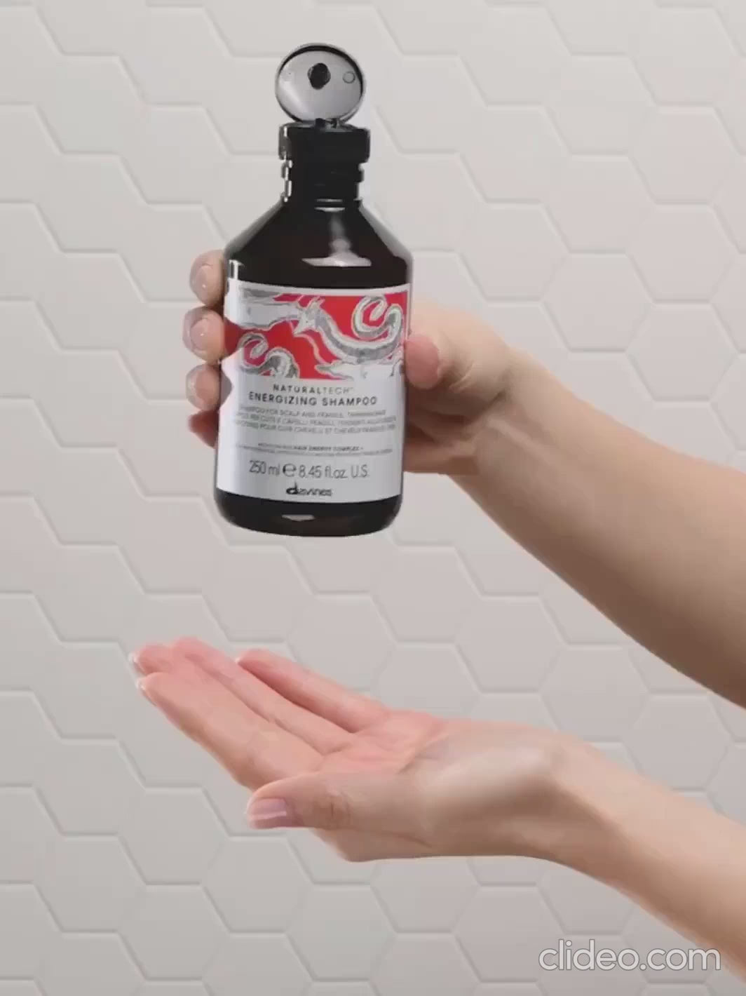 Two hands demonstrating how to use Davines ENERGIZING Shampoo | Twentyseven Toronto