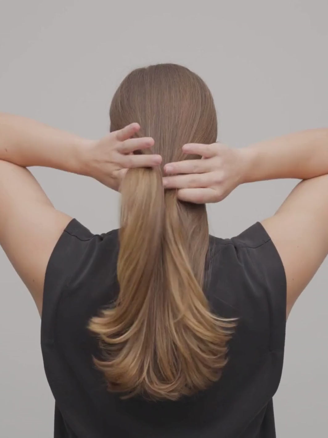 Woman using the MACHETE French Hair Pin to create an updo hairstyle | Twentyseven Toronto