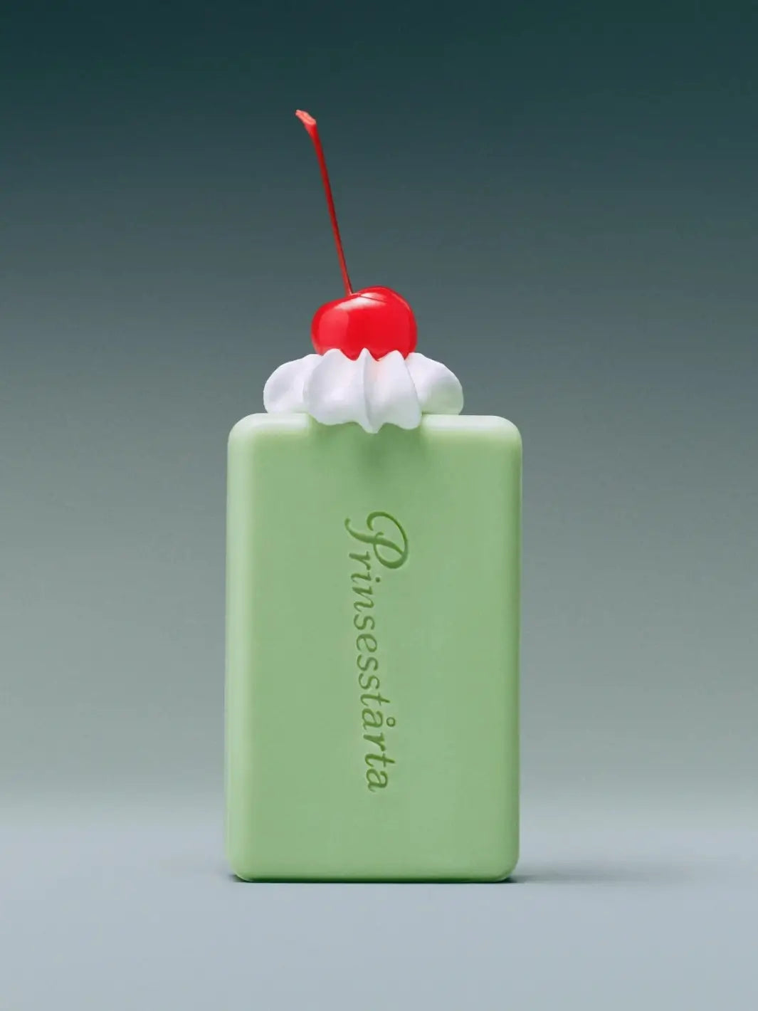 Front view of the rectangular light green Flamingo Estate Prinsesstarta Milk Bar soap decorated with a whipped cream topping and a red maraschino cherry | Twentyseven