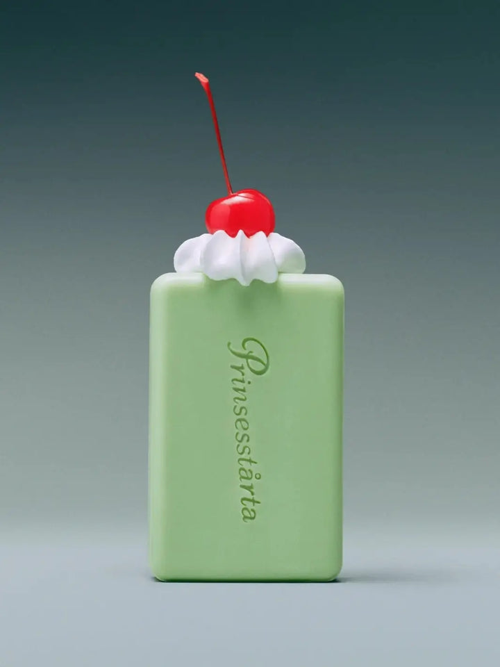 Front view of the rectangular light green Flamingo Estate Prinsesstarta Milk Bar soap decorated with a whipped cream topping and a red maraschino cherry | Twentyseven