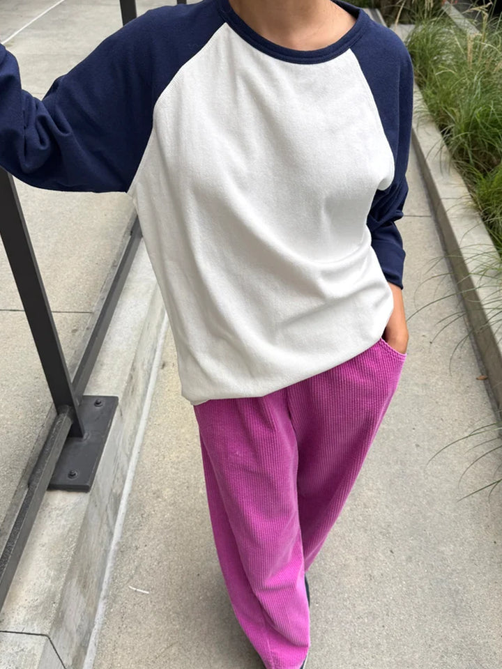 Model wearing the white and midnight navy Le Bon Shoppe Raglan Tee with pink corduroy pants | Twentyseven Toronto