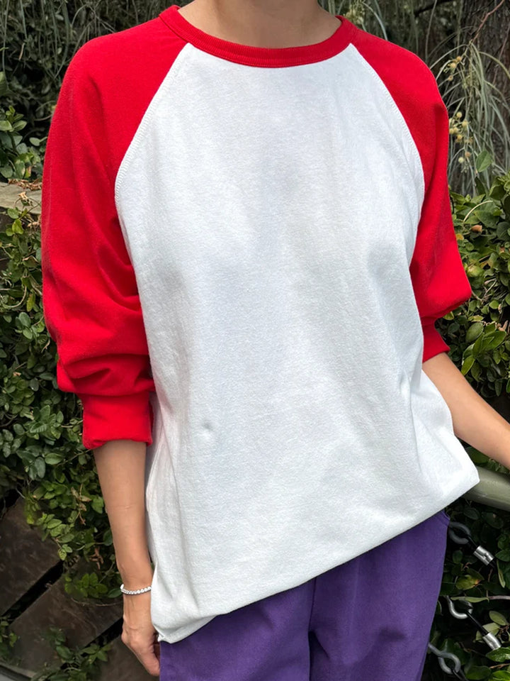 Model wearing the Le Bon Shoppe Raglan Tee in white with tomato red sleeves | Twentyseven Toronto