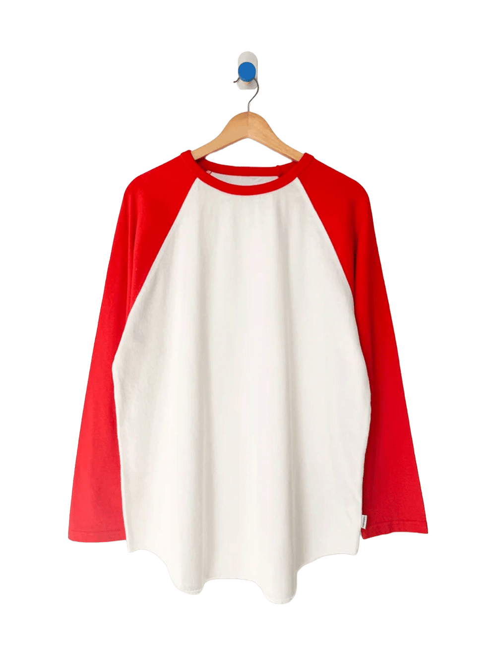 Le Bon Shoppe Raglan Tee in white with tomato red sleeves on a wooden hanger | Twentyseven Toronto