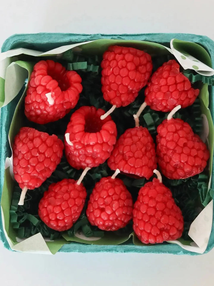 Red raspberry-shaped beeswax candles from Happy Organics in a box on a white background | Twentyseven Toronto